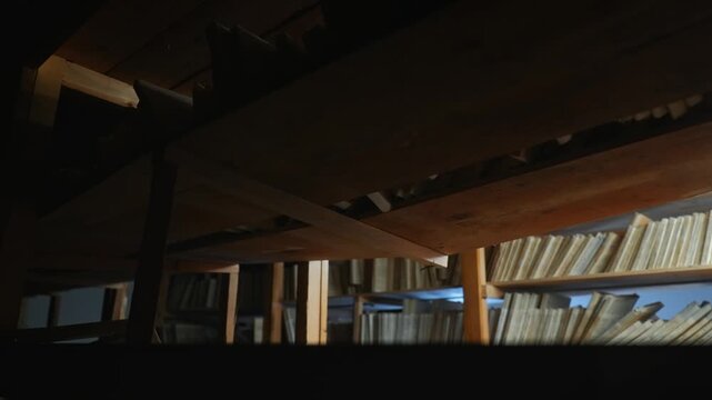 Old archive folders with radio reel recordings stand on wooden shelves in warm light. Concept of audio preservation, media history, library, research, heritage, broadcast archive.