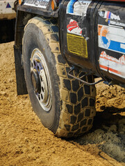 Detail of a tire slightly sunken into the sand. © lapis2380