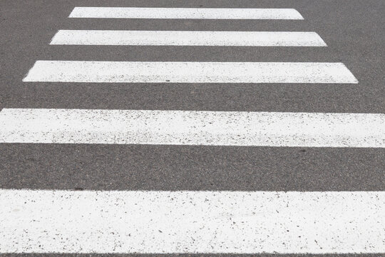 White zebra crossing stripes on dark asphalt street