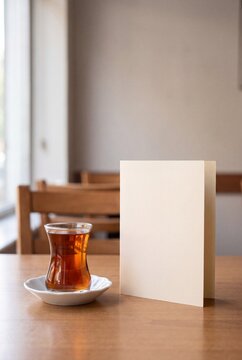 Traditional Turkish Tea Beside Blank Menu Card on Cafe Table