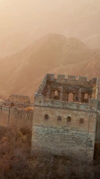 Flying over the Great Wall of China at sunrise. Vertical Video,