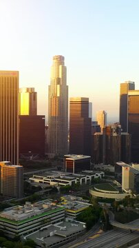 Aerial of the tall buildings of downtown Los Angeles at dawn. Vertical video.
