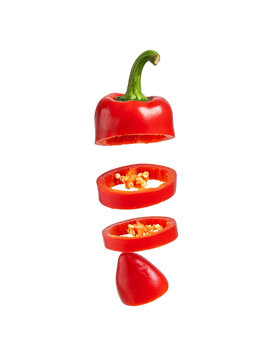 Slices of red bell pepper with seeds stacked vertically against a isolated as PNG