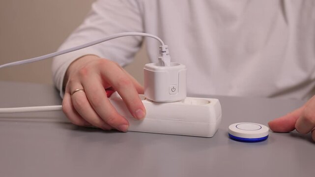 Smart plug handson setup. User demonstrates quick smart socket operation. Individual showcases effortless installation and immediate control of smart electrical devices