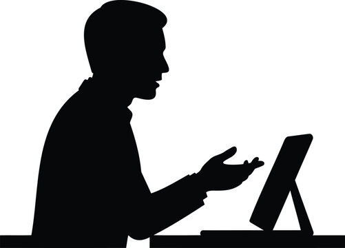 Black silhouette of a man sitting at a desk and gesturing while using a tablet computer, isolated on a white background