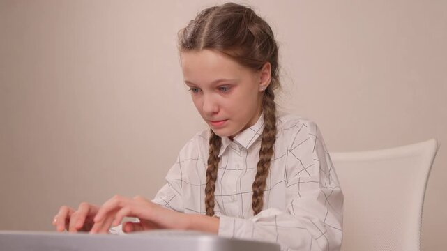 Young female musician rehearsing melodies on digital piano at home. Brightly lit scene of youthful girl honing musical skills on electronic keyboard in cozy environment
