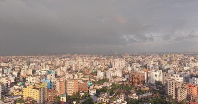 Aerial view of a densely populated urban city landscape in Bangladesh with multi story residential buildings under a cloudy overcast sky