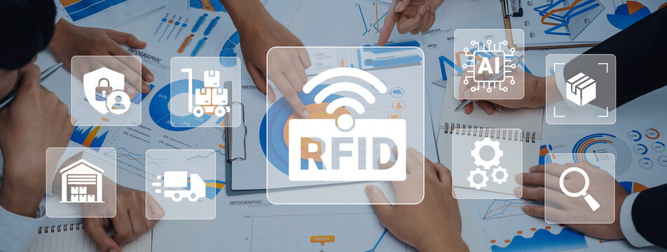 Professionals engage in a business strategy session focused on RFID technology implementation, utilizing charts and graphics for effective supply chain management. Ledger