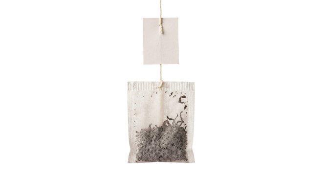 Single tea bag with a blank paper label hanging against a clean white background for design
