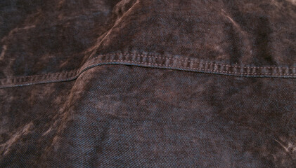 Obraz premium Dark washed denim fabric texture with stitching