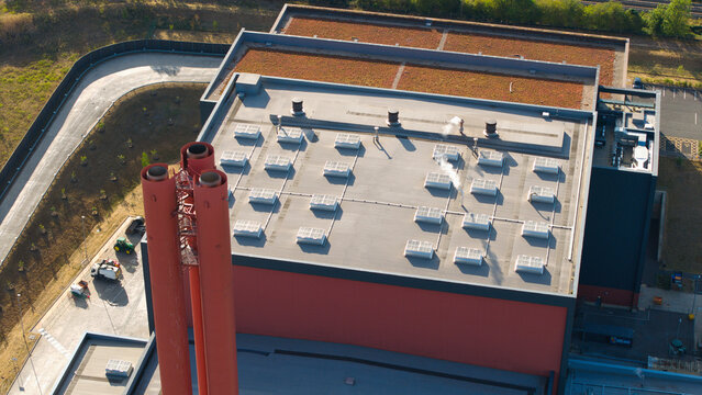 Aerial view of the Rookery South ERF with its distinctive red chimneys, flat roof with skylights, and adjacent green roof section in Stewartby, England, United Kingdom.
