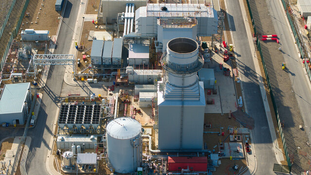 Aerial view of Millbrook Power Plant featuring industrial infrastructure, cooling units, and storage tanks in Stewartby, England, United Kingdom.