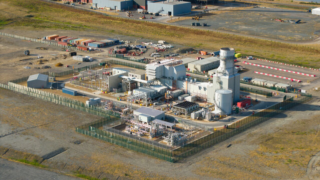 Aerial view of Millbrook Power Plant with its industrial structures, power generation equipment, and fenced perimeter in Stewartby, England, United Kingdom.