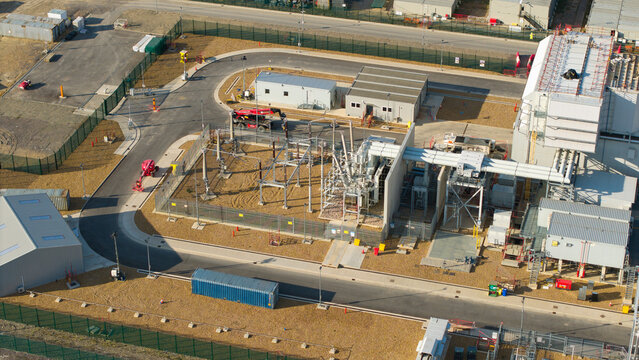 Aerial view of Millbrook Power Plant featuring industrial infrastructure, electrical transformers, and surrounding paved access roads in Stewartby, England, United Kingdom.