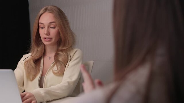 Candidate reviews interview. Job seeker scrutinizes curriculum vitae during interview. Applicant attentively reviews their curriculum vitae during professional interview session