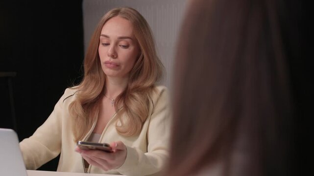 Candidate reviews interview. Job seeker scrutinizes curriculum vitae during interview. Applicant attentively reviews their curriculum vitae during professional interview session