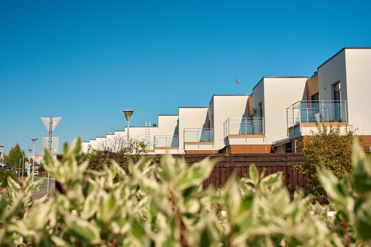Contemporary stepped architecture townhouses against a clear blue sky