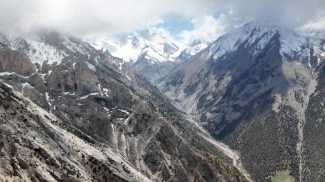 Experience the thrill of rock climbing as daring adventurers ascend a steep cliff, navigating challenging terrain amid breathtaking mountain views.
