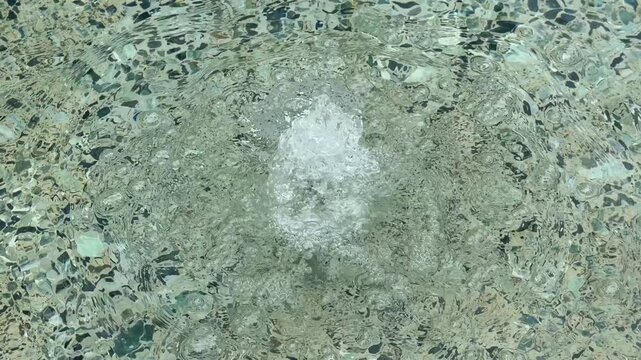 Footage of a concrete aerated water bubbler pond in City Park near a shopping district in the Greater Western Sydney town of Penrith in New South Wales, Australia