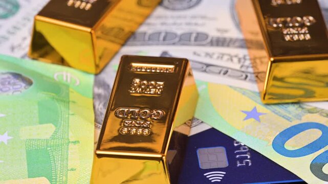featuring US dollar and euro banknotes and gold bars.