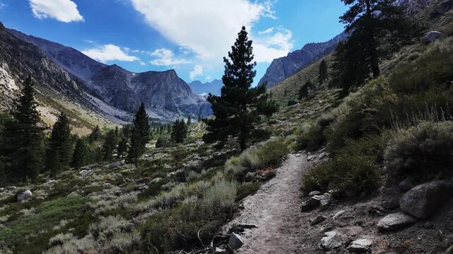 A view of the Big Pine Creek along the Big Pine Trail showing glacial trail in the mountains in the John Muir National Wilderness with the glacial terrain and mountains showing the trail.