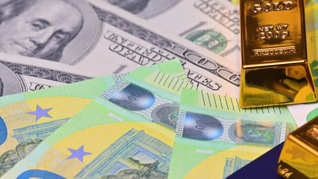 featuring US dollar and euro banknotes and gold bars.
