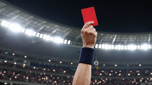 Referee holding up a red card during a football match