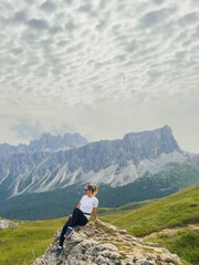Obraz premium tourists walking in the dolomites at giau pass in summer italy