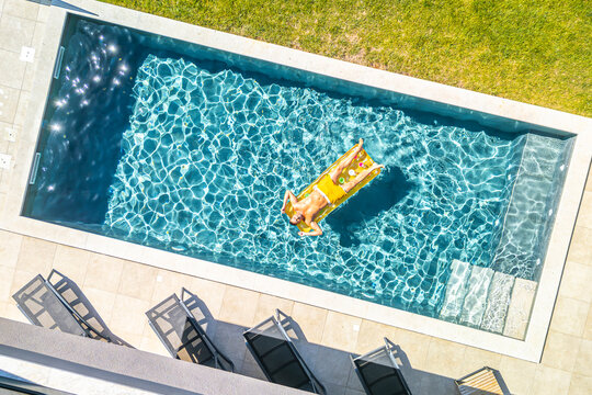 Croatia, Istria, Pula, aerial view of man relaxing at the pool