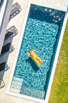 Croatia, Istria, Pula, aerial view of man relaxing at the pool