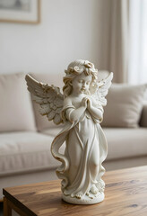 Obraz premium Spirituality and peace, small angel statue with praying hands for home decor and religious meditation in a bright living room interior setting
