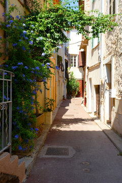 Narrow sunlit alley in Antibes Old Town, French Riviera, France