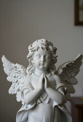 Obraz premium Spirituality and faith marble angel statue with hands in prayer religious devotion and peace memorial sculpture for funeral or cemetery decoration
