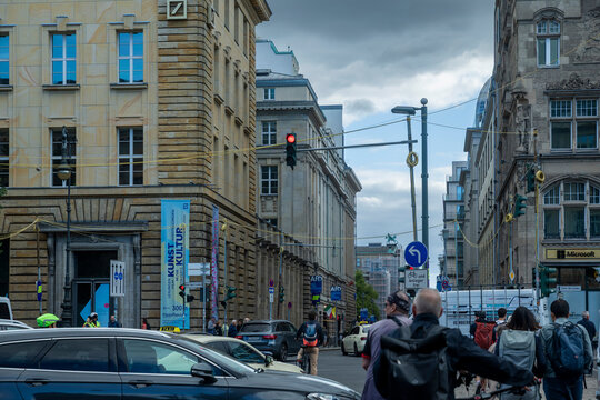 Berlin, Germany, Street view along Unter den Linden showing traffic, pedestrians, historic architecture, and the PalaisPopulaire art space banner.
KEYWORDS: