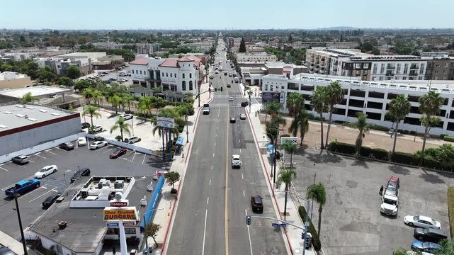 Bellflower, California, USA - Drone Aerial View of Downtown Shops, Restaurants, Storefronts and People Walking Along Commercial District With Small-Town Main Street Vibe on a Sunny Day