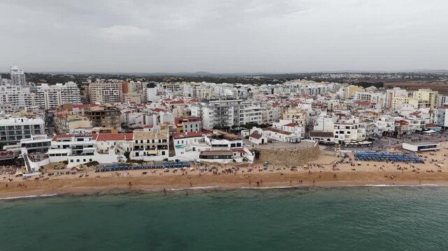 Aerial drone flying over armacao de pera beach and cityscape