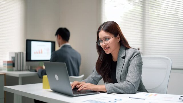 Businesswoman Working on Laptop in Modern Office