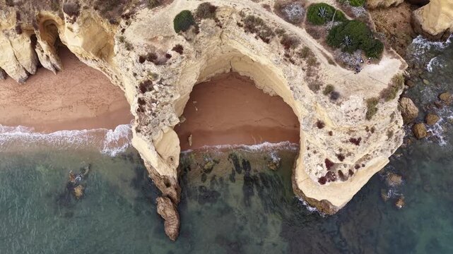 Aerial top-down view rising over armacao de pera rock formations