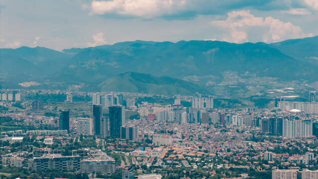 Aerial view of the Paseo Arcos Bosques complex featuring modern skyscrapers and urban density with mountains in the background in Ciudad de Mexico, Ciudad de Mexico, Mexico.