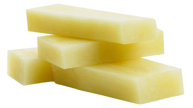 Isolated stack of smooth, pale yellow rectangular blocks, resembling industrial wax or soap base.