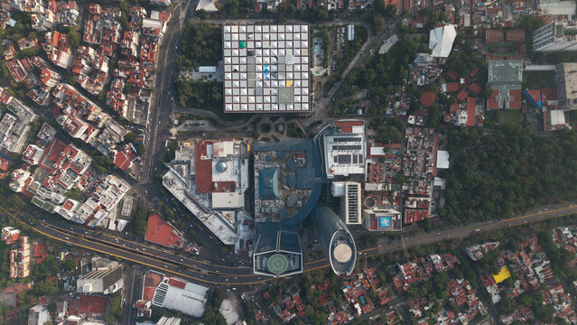 Aerial view of the urban landscape featuring modern architecture, dense residential areas, and green spaces in Mexico City, Mexico City, Mexico.