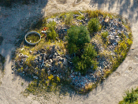 Aerial view illegal dumping construction waste contaminating green environment