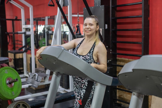 A woman with cerebral palsy walks on a treadmill. 