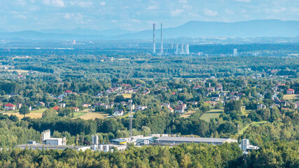Fototapeta premium Rybnik landscape showing power plant chimneys, residential area, and forests