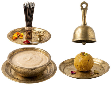 A collection of traditional Hindu puja items including a brass bell, sandalwood paste, incense sticks, and a golden laddoo sweet for festival worship.