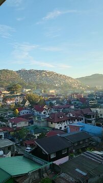 Sunrise over Baguio City, Philippines, morning light on mountains and rooftops, vertical video