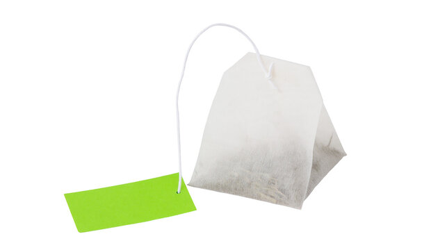Isolated unbrewed tea bag with a plain green tag, ready for making a refreshing hot drink.
