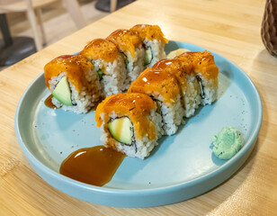 Vegan sushi rolls with avocado and sauce on a plate in Barcelona © Tomas Bazant