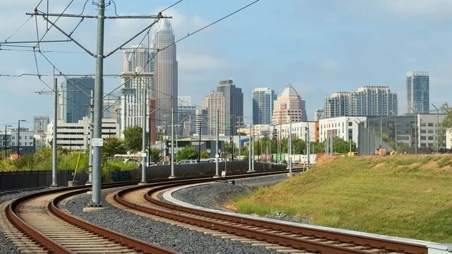 View of uptown Charlotte, NC with an approaching transit light rail train