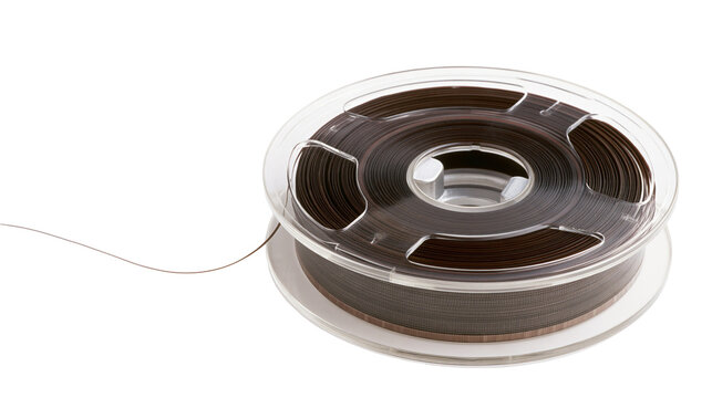 Isolated retro magnetic tape reel with brown recording film unwinding from clear plastic spool